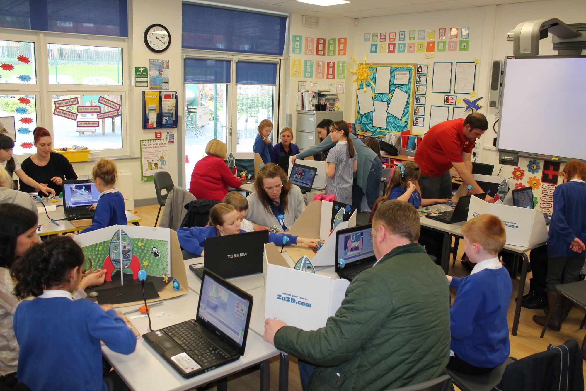 A classroom of children animating with Zu3D, a family learning day with parents helping