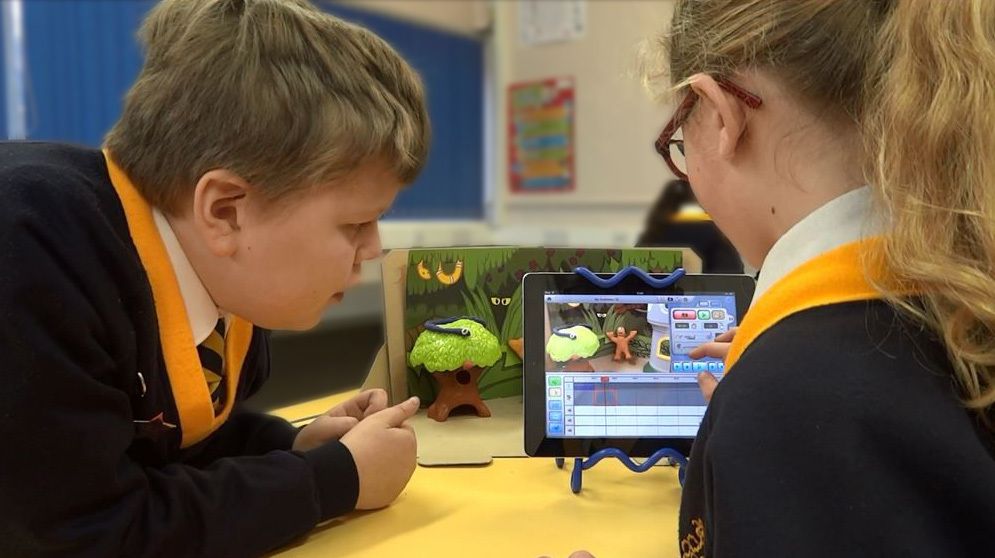 Two children animating on an iPad in a classroom at school